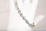 Ladies 14k Yellow Gold Oval Cut Synthetic Aquamarine Tennis Bracelet 7.75"