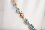 Ladies 14k Yellow Gold Oval Cut Synthetic Aquamarine Tennis Bracelet 7.75"