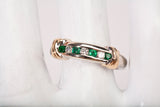 Ladies 14k Two-Tone Channel Set Diamond and Emerald Half Eternity Band