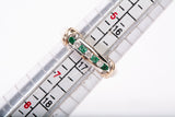 Ladies 14k Two-Tone Channel Set Diamond and Emerald Half Eternity Band