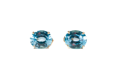 Ladies 14k Yellow Gold Oval Cut Blue Topaz Stud Earrings